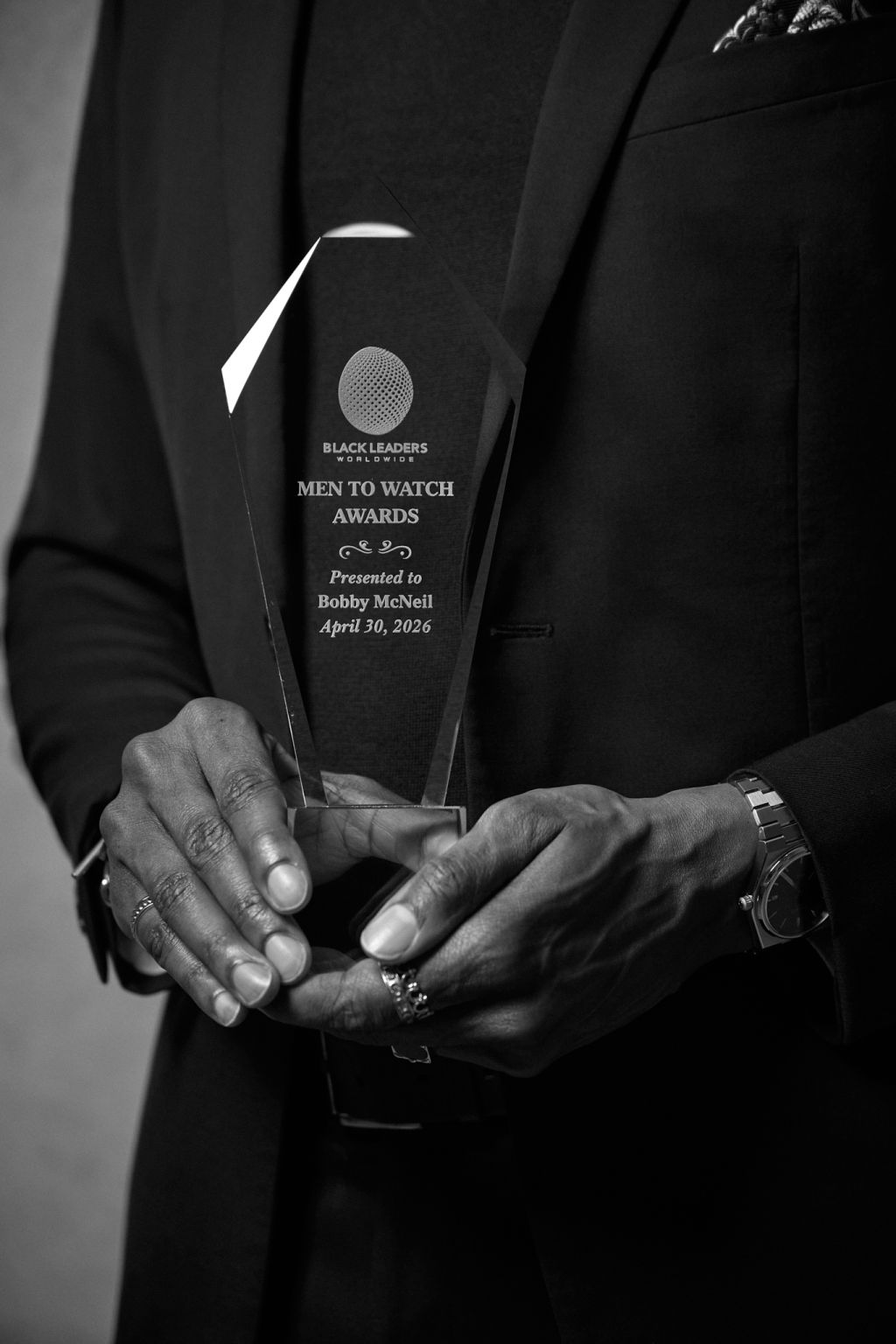 Bobby McNeil Jr. holding the Black Leaders Worldwide Men to Watch award