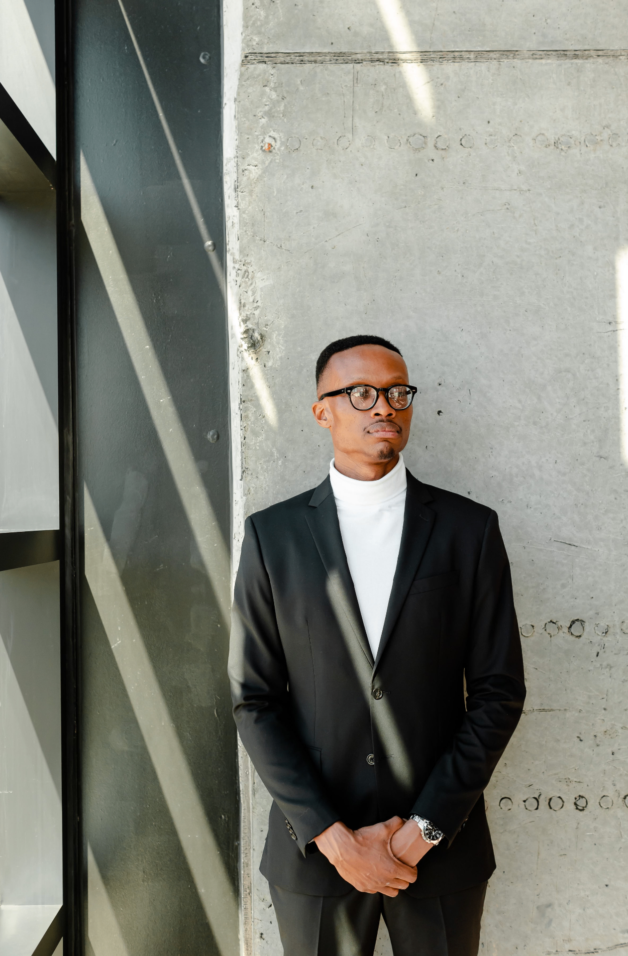 Bobby McNeil Jr. in a black suit and white turtleneck